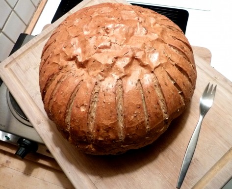The Sissel Bread from Kaplan's Rainbow Bakery, photographed on a 14 by 20-inch cutting board and with a dinner fork for scale. Despite it's size, it weighs only just over 3 pounds.