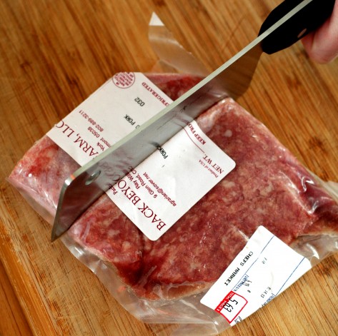 With the aid a mallet, the cleaver easily works its way through a package of frozen pork from Back Beyond Farm, located in Tunbridge, Vermont.