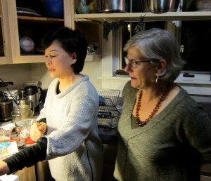 Authors Taekyung Chung and Debra Samuels conferring over the Tofu and Clam Hot Pot while at the potluck in Vermont. (Photo by Mark Goodwin.)